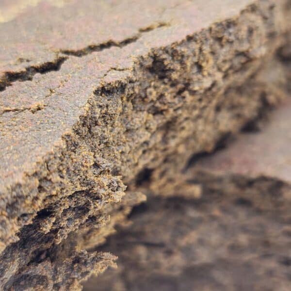 Close-up of premium hashish with a rich, crumbly texture, highlighting the quality of hash products available online.